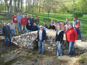 Penn College students and horticulture faculty members gather around the latest mortarless creation for the School of Natural Resources Management.