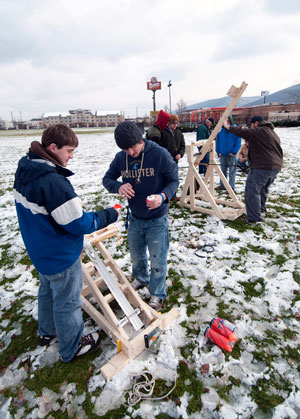 Pennsylvania College of Technology students Christopher W. Laukhuff, of Lititz, and Brian J. Borror, of Dover, foreground, prepare their ballista for its test launch.