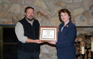 Justin W. Beishline, a diesel equipment technology instructor at Pennsylvania College of Technology, receives a Pathfinder to Excellence Award from Mary A. Sullivan, dean of natural resources management.