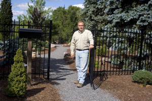 Carl J. Bower Jr., a member of the horticulture faculty in Pennsylvania College of Technology%E2%80%99s School of Natural Resources Management, stands at the entrance to the conifer garden at the college%E2%80%99s Schneebeli Earth Science Center near Allenwood.%0A