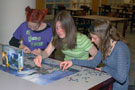 Assembling a Hogwarts puzzle on the library's second floor are, from left, Williamsporters Alyssa Gregory, Olivia Angevine and Maria Balestino