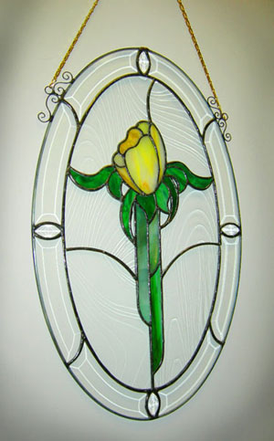 Stained-glass yellow tulip, created by faculty member Keith Whitesel and won by Sandra Linn, among Annual Fund Employee Campaign prizes.