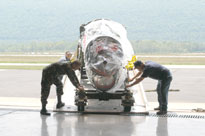 Equipment rolls off the truck and into the Aviation Center hangar