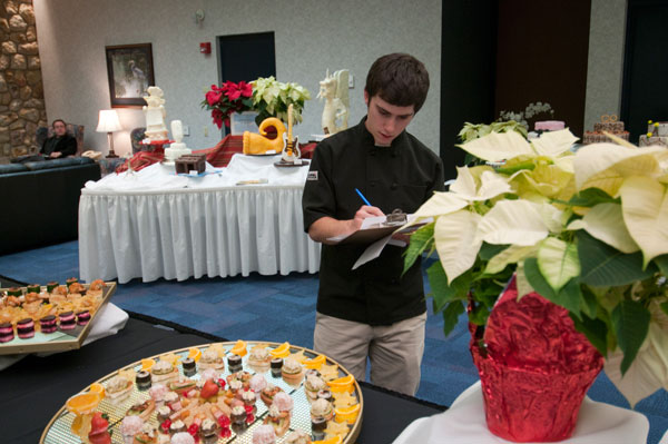 Food Show judge Jon Sherwood, sous chef at Elizabeths An American Bistro in Lewisburg, looks over entries from the Advanced Garde Manger course.