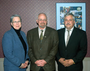Brian Moore (center), industry education coordinator for American Honda Motor Co. Inc., is joined by Penn College President Dr. Davie Jane Gilmour and Colin W. Williamson, dean of transportation technology.