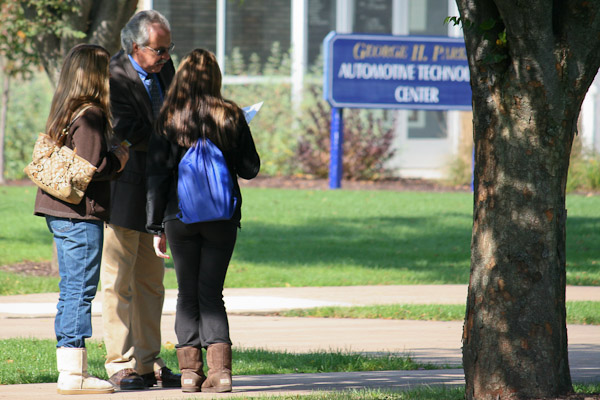 Along a sun-dappled campus mall, Tom Gregory, associate vice president for instruction, pauses to offer guidance.