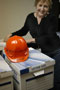 Library director Lisette N. Ormsbee, with packed boxes - and a personalized hard hat