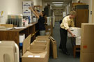 Christi J. Crist, a student intern from Canton, organizes boxes while Keith M. Saboski, library circulation specialist, moves the packed files