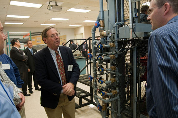 Jay Waddell, founding partner and key management principal of Plastic Concepts & Innovations, LLC, talks about the thermoforming equipment with guests who toured the colleges renovated plastics facilities as part of the ribbon-cutting event.