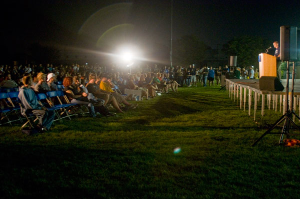 Students gather near the Field House on Sunday night, awaiting the fireworks display while hearing from campus leaders.