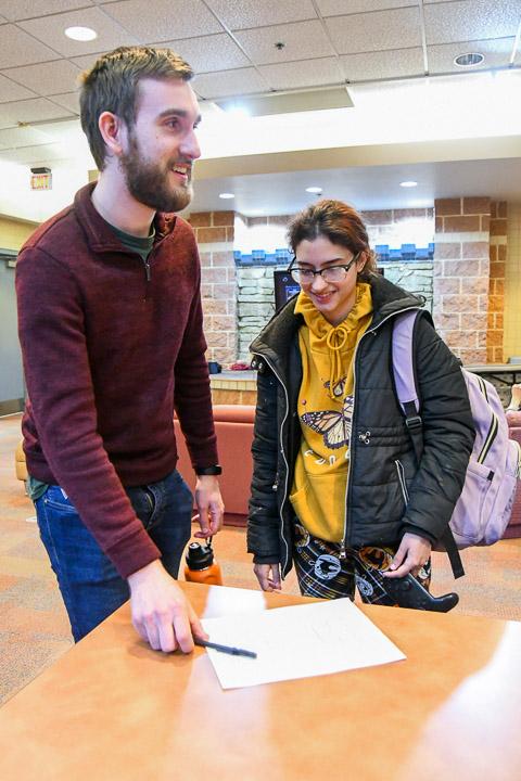 Ben G. Pace, a 2021 industrial design alum, and graphic design student Jessica D. Aviles register for the competition.