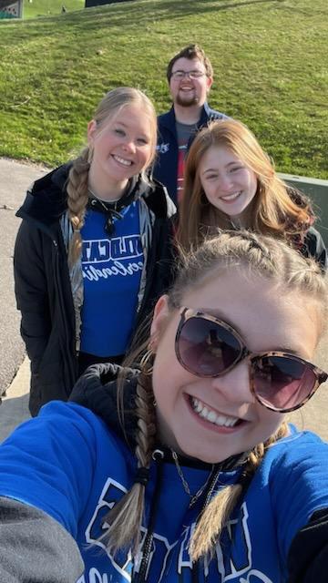 Penn College cheerleaders (from front to back) Albert, Brinker and Campbell join RA Schooley in running a water station.