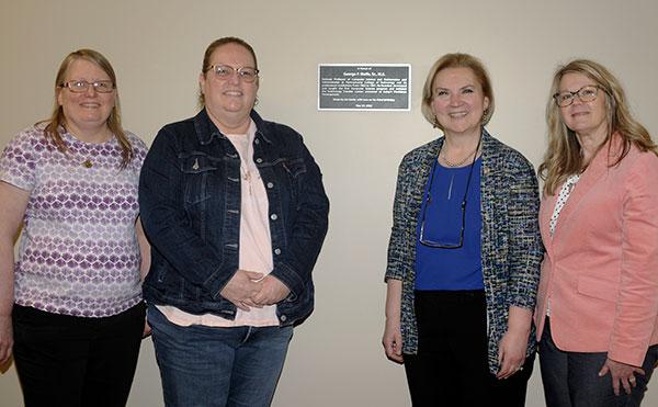 The birth of the college's computing program, which has grown to seven majors enrolling more than 200 students, is marked by a memorial plaque installed on Monday afternoon. From left are Sandra Gorka, professor of computer science and department head; Brenda J. Wolfe, one of George P. Wolfe Sr.'s children; Nesli Alp, vice president for academic affairs/provost; and Stacey C. Hampton, assistant dean of industrial and computer technologies.
