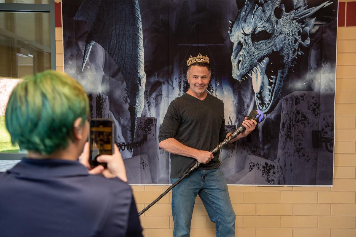 Strike a pose! Kae A. Little, human services & restorative justice, snaps a fun photo of counselor (and occasional dragonslayer) Michael S. DiPalma at the fantasy photo backdrop.  