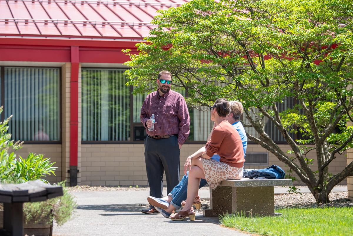 Employees, including Justin W. Beishline, assistant dean of diesel technology and natural resources, relish courtyard conversation.