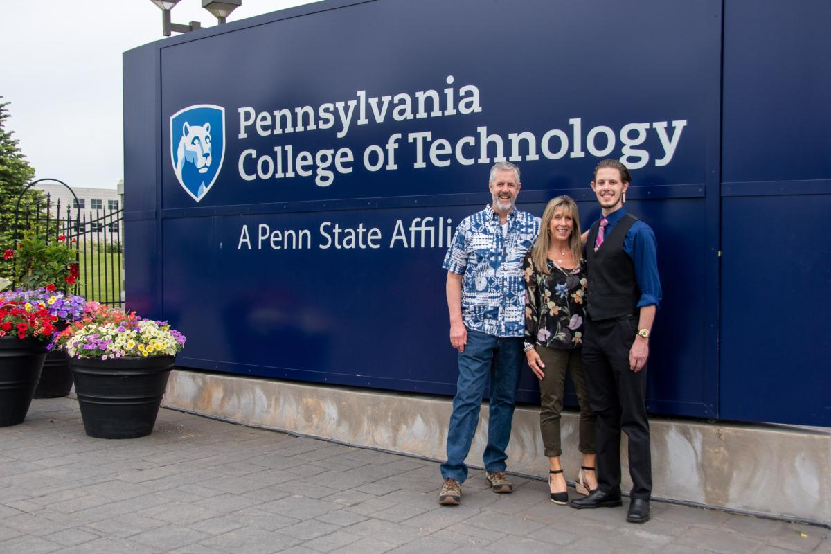 Zak Smith (right) celebrates with family at the college entrance. Smith earned degrees in welding & fabrication engineering technology and welding technology.