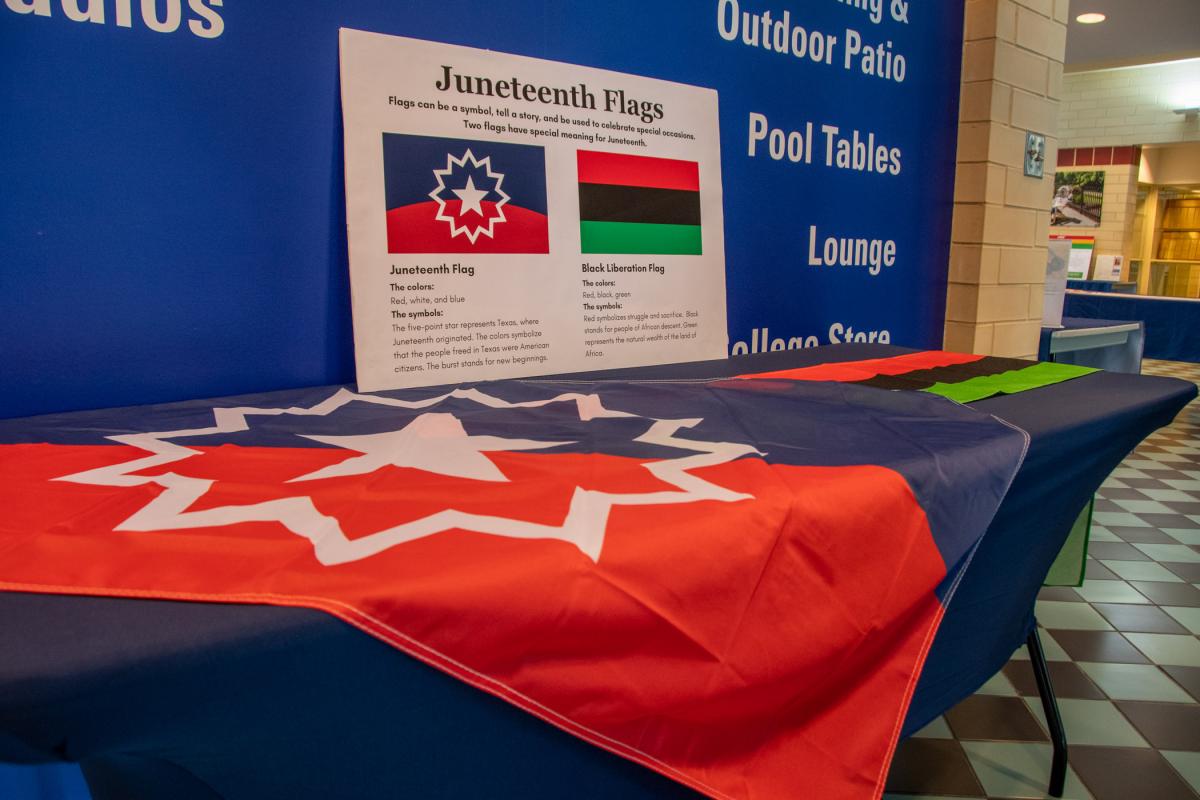Inside the Bush Campus Center, a wealth of information is offered, including the meaning behind the Juneteenth flag: Its five-point star represents Texas, where Juneteenth originated, and its burst stands for new beginnings. The colors symbolize the American citizenship of the freed Texans. The colors of the red, black and green Black liberation flag represent struggle and sacrifice (red), people of African descent (black) and the natural wealth of the land of Africa (green).