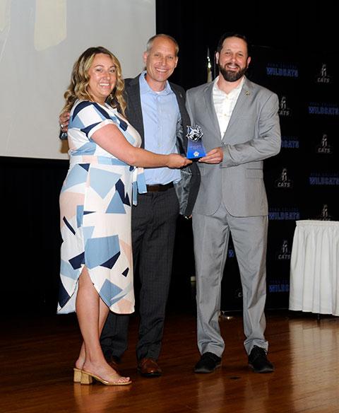 Kennell (center) presents staff awards to assistant directors Britni E. Mohney and Matt J. Blymier.