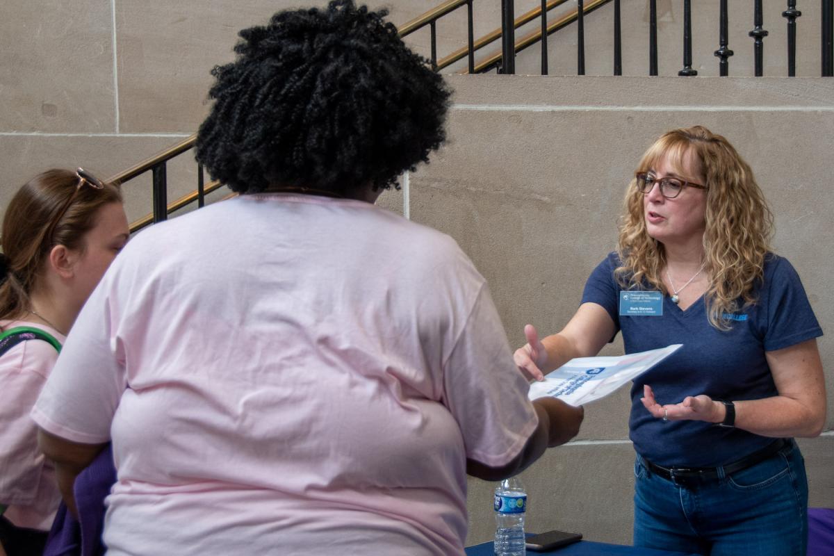 As guests enter the Academic Center, Barbara J. Stevens, secretary of K-12 Outreach, provides a friendly first introduction to the day’s activities.