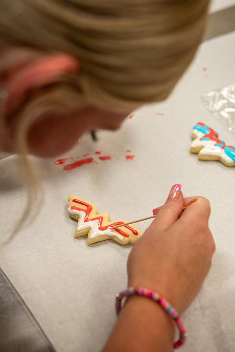 Later in the day, the girls decorated their Wonder Woman cookies in a baking lab ...