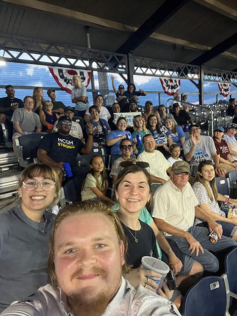 Alumni and their Penn College hosts look toward Ryan Freidhof, a 2022 radiography graduate, at the head of a group selfie.