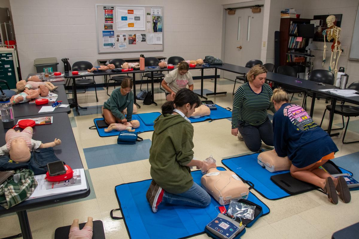 Participants get hands-on practice with the guidance of Kathy L. Kling, an instructor of basic life support (EMT/EMR) for Penn College Workforce Development, and Katharine R. Kieser (not in photograph), also a Workforce Development instructor for basic life support (EMT/EMR).