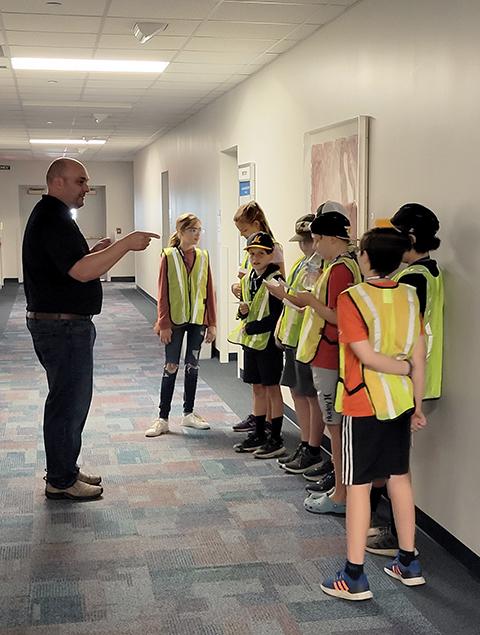 William A. Schlosser, emergency management and homeland security instructor, disperses "victims" to hide in darkened rooms on the Klump Academic Center's fourth floor ...