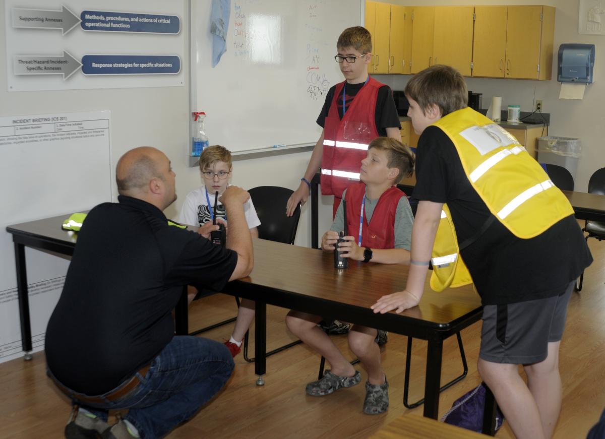 ... and schools their colleagues on the logistics of a search-and-rescue operation.