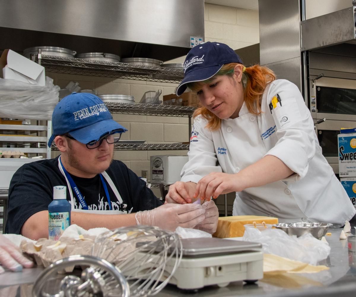 Lab assistant and Le Jeune Chef intern Amber R. Harris, a baking & pastry arts student from Sciota, lends a hand.