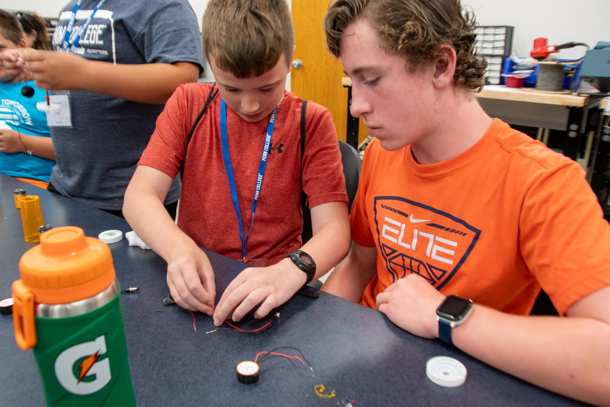 Participants join components before soldering.