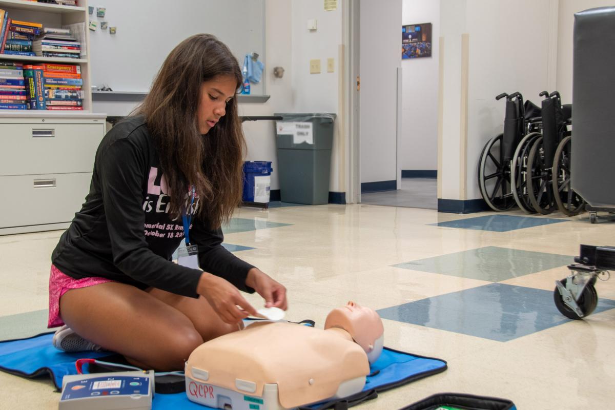 In the Paramedic Lab, a participant places the electrode pads of an AED.