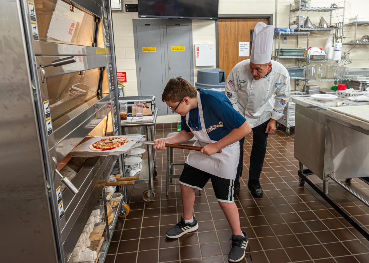 Chef Todd M. Keeley, assistant professor of baking and pastry/culinary, supervises use of the oven ...