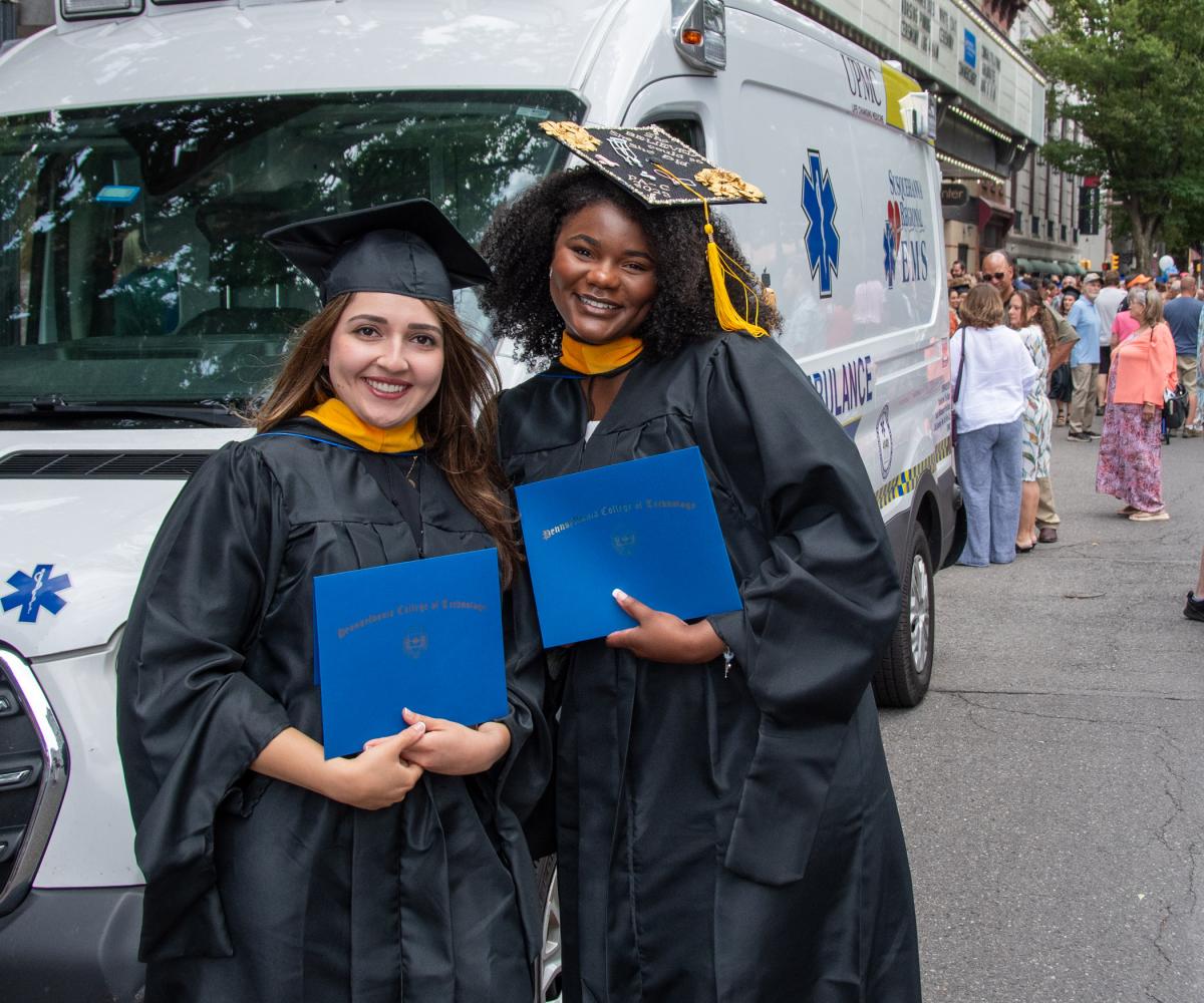 Physician assistant studies graduates Fatma R. Hassan and Kori-Ann A. Taylor, both of Williamsport, celebrate after the ceremony.