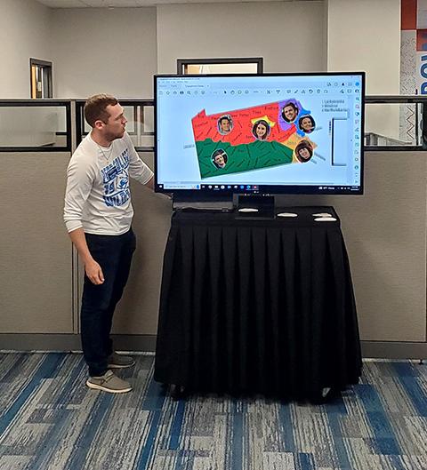 Bogaczyk walks attendees through the map of Pennsylvania, divided into coverage areas and marked by recruiters' head shots.