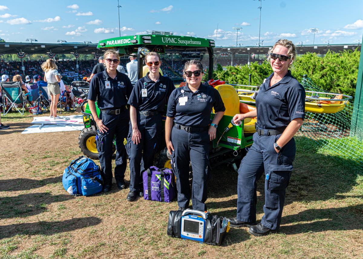 Pennsylvania College of Technology paramedic science students Kaylin J. Hicks, of Hughesville; Elizabeth A. Goodrich, of Middlebury Center; Aleyah D. Walter, of Hughesville; and Allison Lavallee Harris, of Williamsport, spend a day at the Little League World Series complex in 2022, working with paramedics from Susquehanna Regional EMS, to provide emergency care to Little League spectators. Ten Penn College paramedic students will do the same this year.