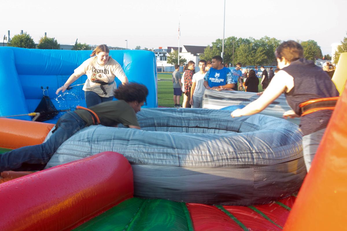 A human version of "Hungry, Hungry Hippos" sends students head-first into an inflatable arena.