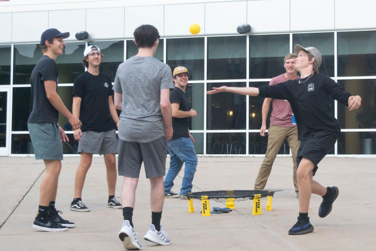 Students enjoy a game of Spike Ball, which adds a small trampoline to a volleyball sensibility.