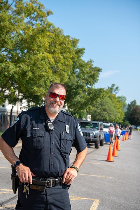 With sunglasses that match the orange traffic cones, Penn College Police Officer Jeffrey E. Kriner is always standing by on move-in day – equipped with guidance and graciousness.