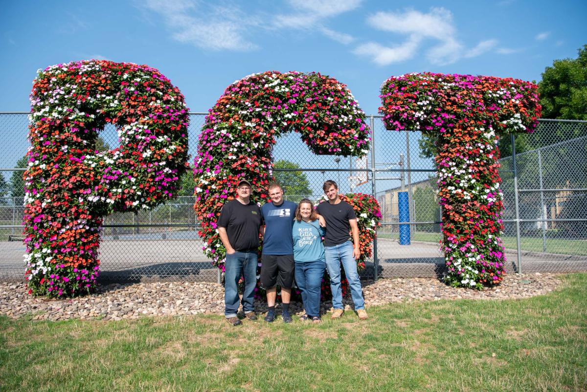 Appropriately enough, this new student in landscape/plant production technology savors a family photo at a fantastic floral landmark: Jared E. Andrews (second from left) is from Perkasie.