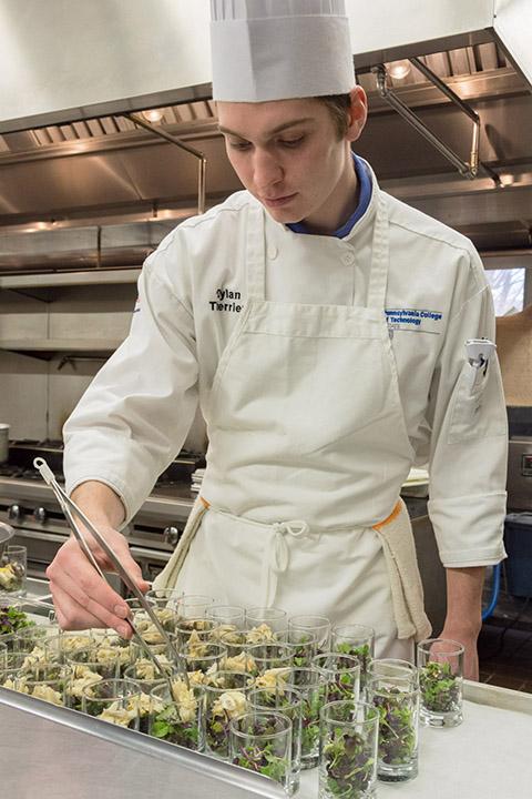 Dylan Therrien, ’18, prepares hors d’oeuvres in the college’s Le Jeune Chef Restaurant during the Spring 2018 Visiting Chef event.