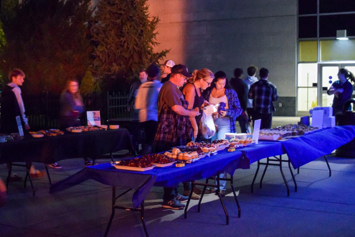 Guests choose from among treat-laden tables at a Dessert Showcase outside The Madigan Library.