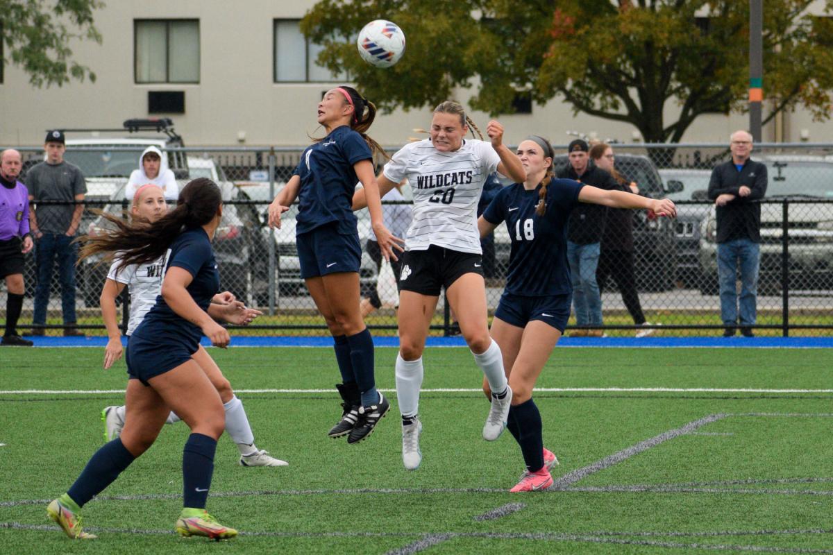 Forward Sara Darlington leaps into the fray. The Wildcats played to a scoreless tie against the Nittany Lions, aided by Nicole Lichtinger's record 11 saves in goal.