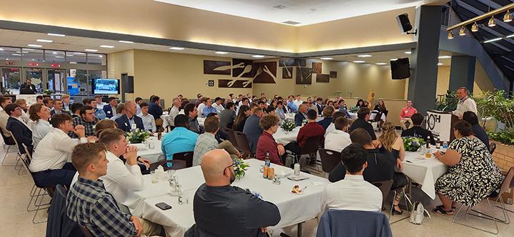 An attentive banquet crowd listens to Michael J. Cook, the first faculty member in Penn College's construction management program.