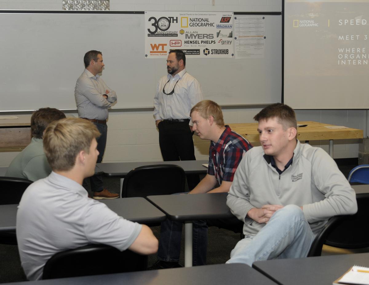 Ryan A. Sokoloski (left rear), director of building operations for National Geographic – currently overseeing a colossal transformation of the society's museum space in the nation's capital – leads students through a "Speed Networking" exercise. Sokoloski, '08, talking with Lee D. Michaels ('11, another alumni returnee), suggested audience members consider a more natural form of professional interaction, building a network from contacts made as they move through their careers.