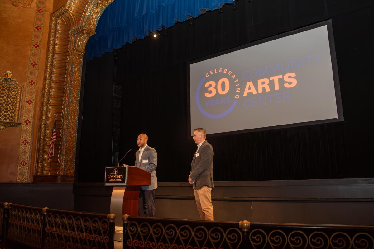Williamsport Mayor Derek Slaughter (at podium) delivers a proclamation addressing the Community Arts Center’s 30-year history during a PM Exchange held Aug. 31 for members of the Williamsport/Lycoming Chamber of Commerce. At right is CAC Executive Director Jim Dougherty. 