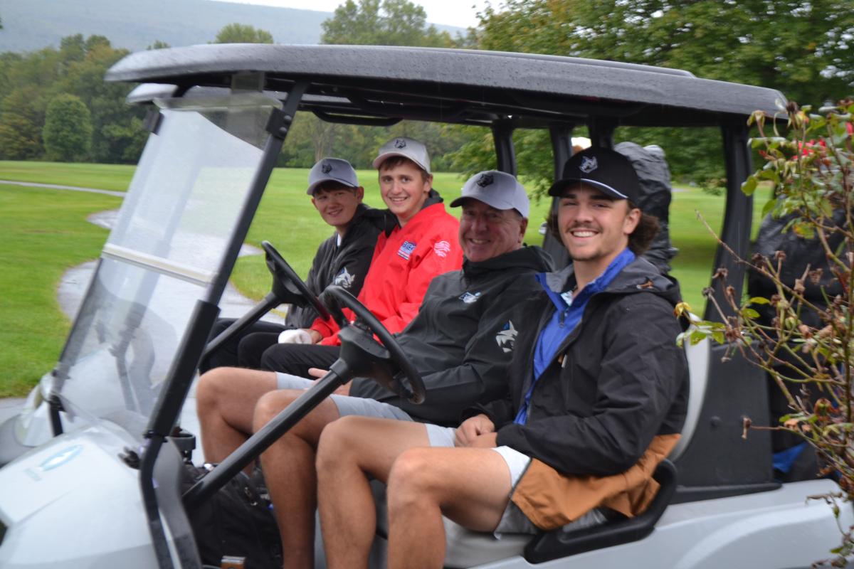 "It never rains on the golf course," it's said ... but carts have roofs, just in case. Current Wildcats making the best of their day  – and their friendly rivalry against past Penn College golfers – are (back to front) Gunner E. Redmond, Gavin L. Baer, coach Rob Lytle and Peyton M. Mussina. A signed baseball from Peyton's dad, former MLB pitcher Mike Mussina, was among the items raffled in a benefit for the team.