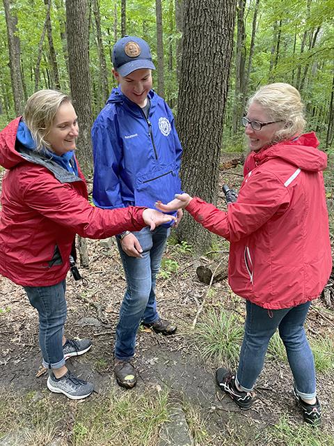 Stopping to appreciate an eastern newt in its woodland habitat are James C. Fretz, of Collegeville, a construction management student and college relations assistant; his mother, Rebecca (left); and his aunt, Cynthia Gehman.