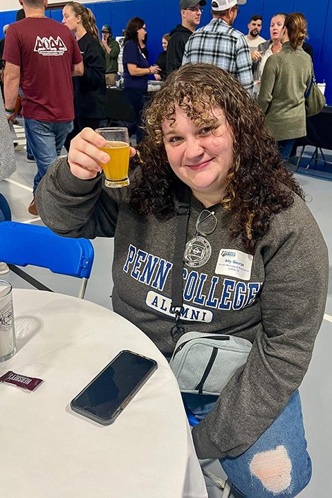 Ally M. George, ’22, human services & restorative justice, cheers a successful alumni evening.