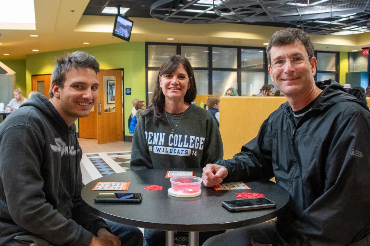 Bonding around the bingo table are Alex S. Broyles, an automotive technology student from Chadds Ford, and his parents, Melissa and David.