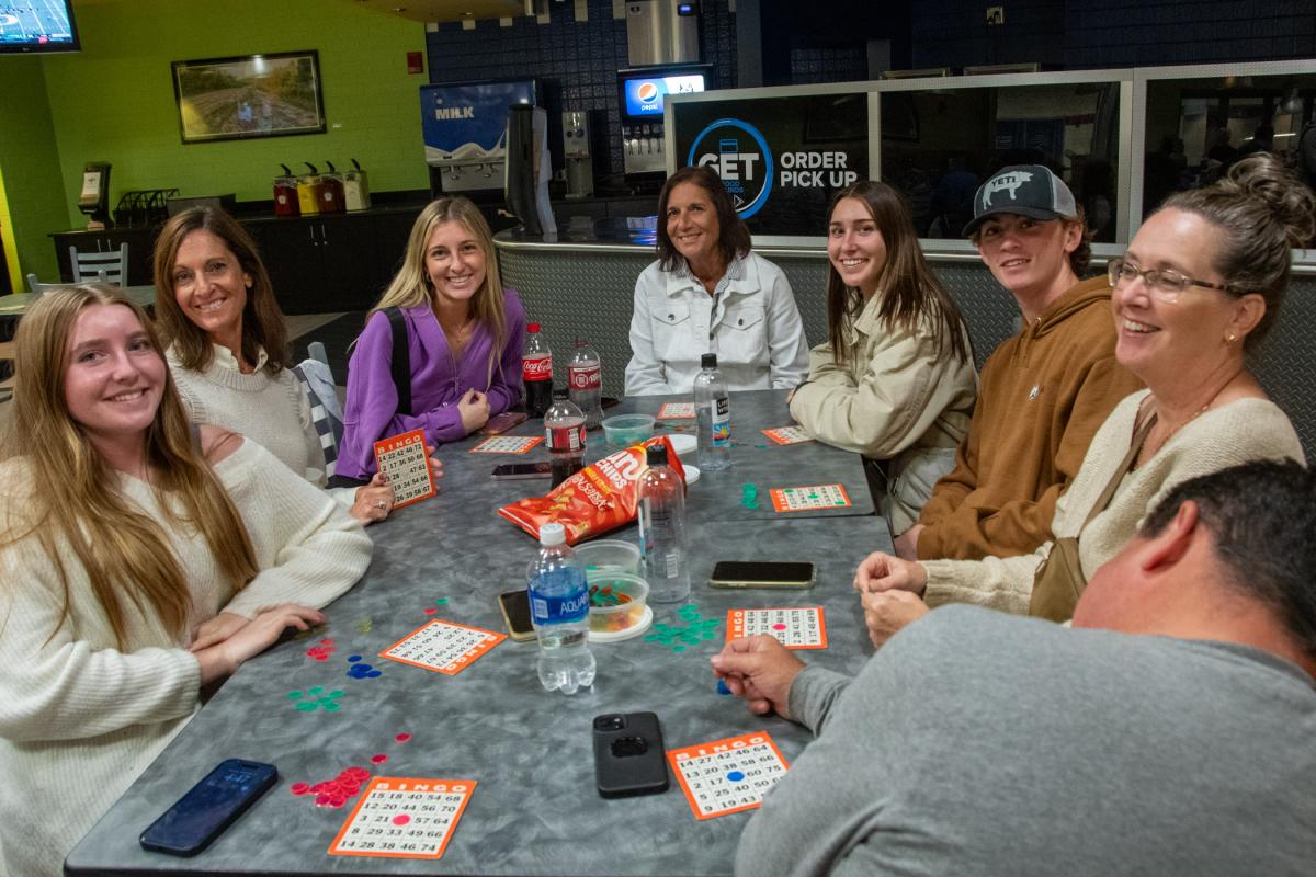 Payton S. Stief (third from left), a pre-radiography student from Lancaster, and Meg R. Agan (fifth from left), a pre-dental hygiene student from Elmira, N.Y., and their families gather in CC Commons to play for their chance to win Penn College prizes.